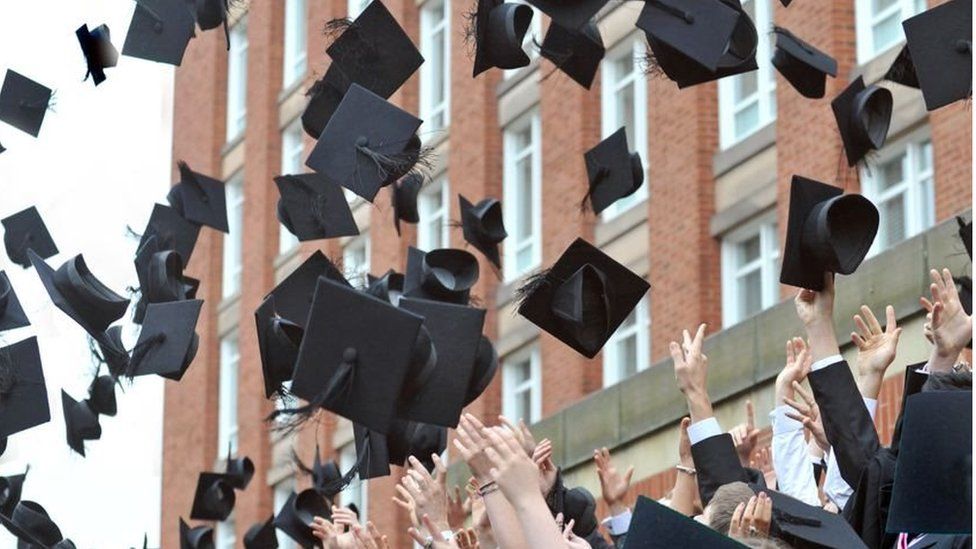 University Graduates toss their mortar boards into the air in celebration during graduation day at the University of Birmingham - 2010