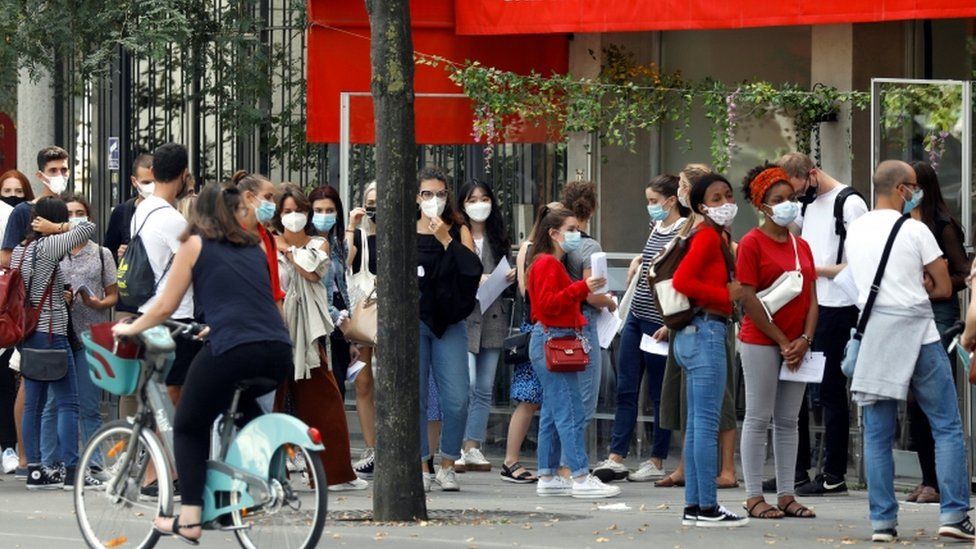 A crowd of people wearing masks in Paris