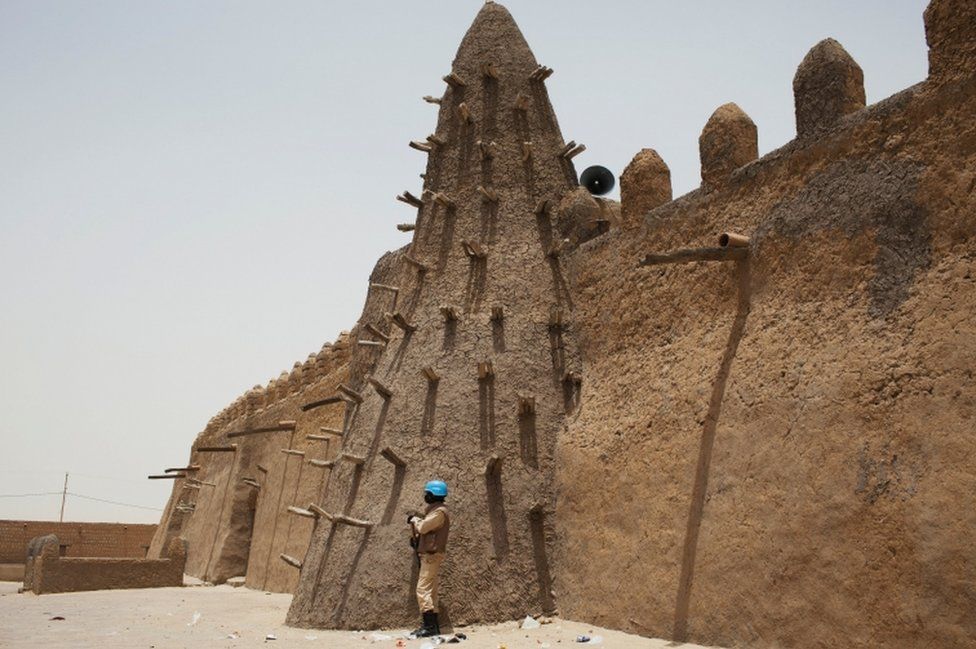 A UN peacekeeper from Burkina Faso stands guard at the 14th Century Djinguereber mosque in Timbuktu, Mali