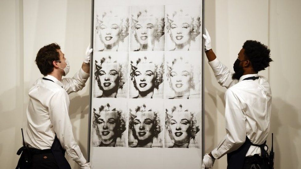 Sotheby's employees hold US artist Andy Warhol"s 'Nine Marilyn's'