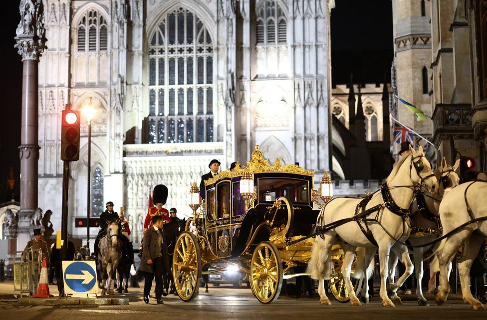 The Diamond Jubilee Coach is ridden alongside members of the military during a full overnight dress rehearsal of the Coronation Ceremony.