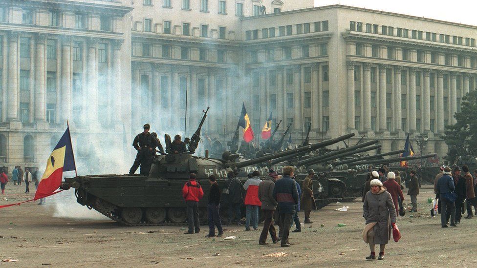 Tanks outside a government building in Bucharest during the Romanian revolution