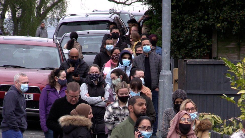 People queue at a vaccination centre in Bolton