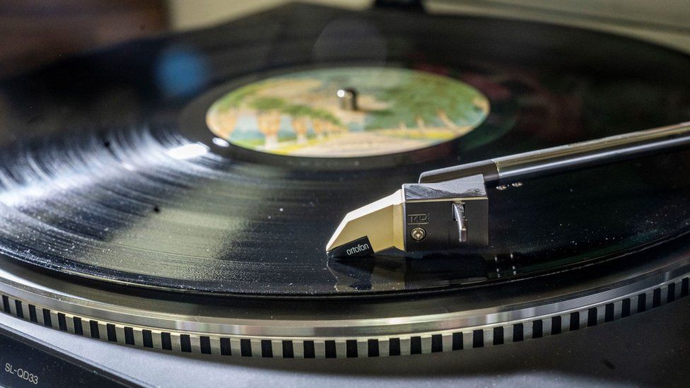 Vinyl record spins on record player.