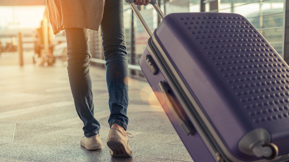 Airline rider  pulling suitcase