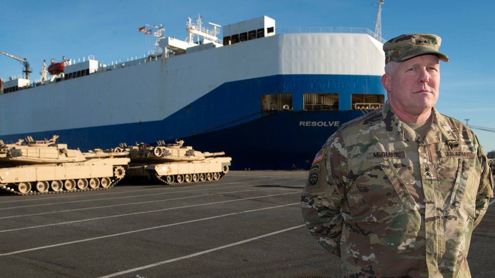 Timothy McGuire, Major General and Deputy Commanding General United States Army Europe, stands in front of US Army tanks and the cargo vessel "Resolve" in Bremerhaven, northern Germany