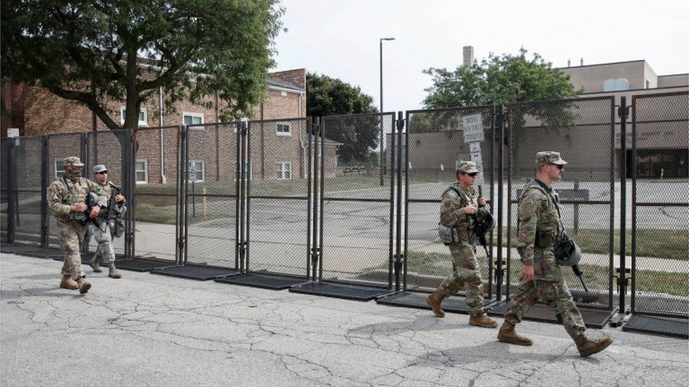 Members of the Wisconsin National Guard arrive at Kenosha County Public Safety Building on 31 August