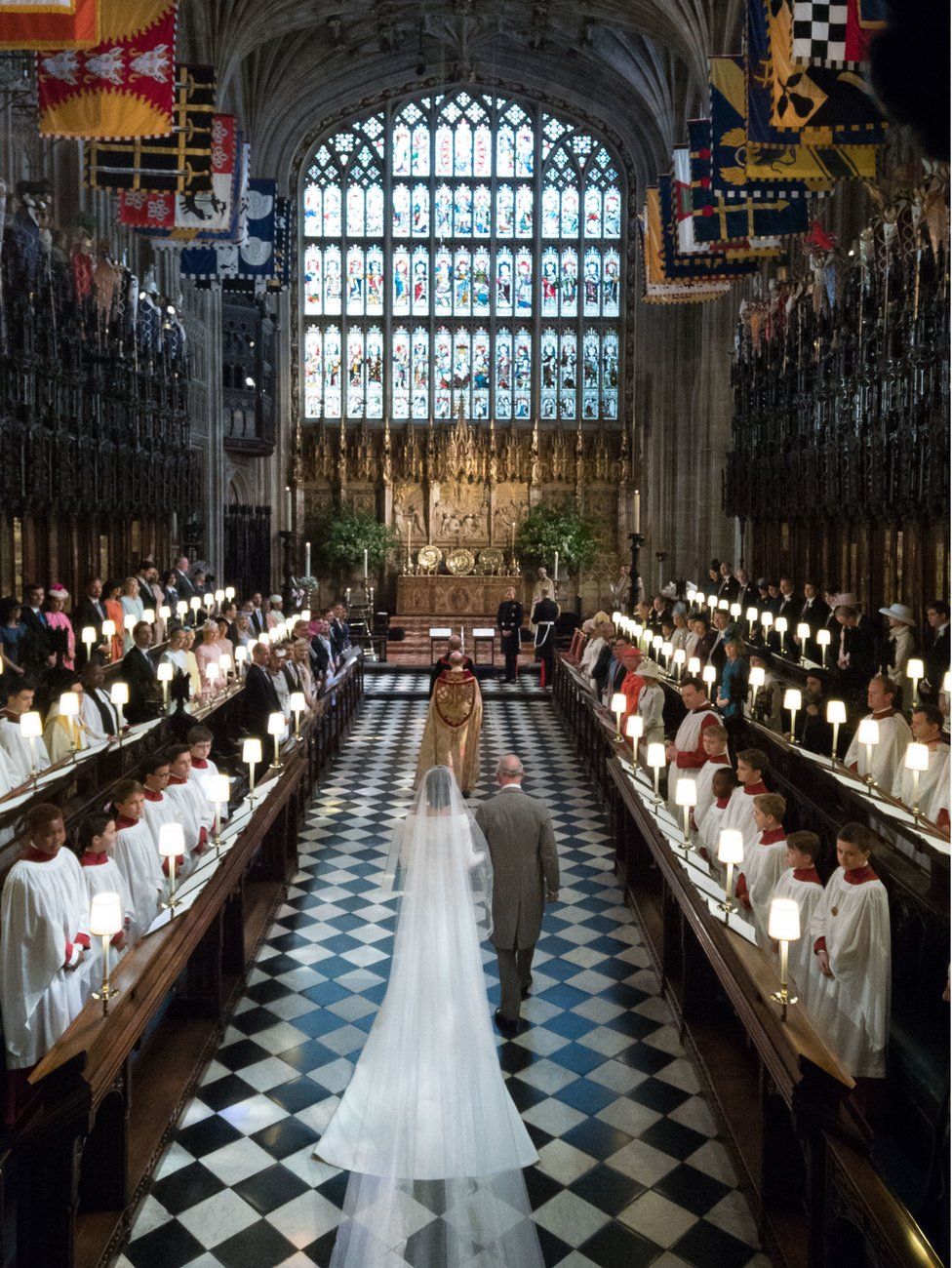 Meghan Markle walks up the aisle with the Prince of Wales at St George"s Chapel at Windsor Castle