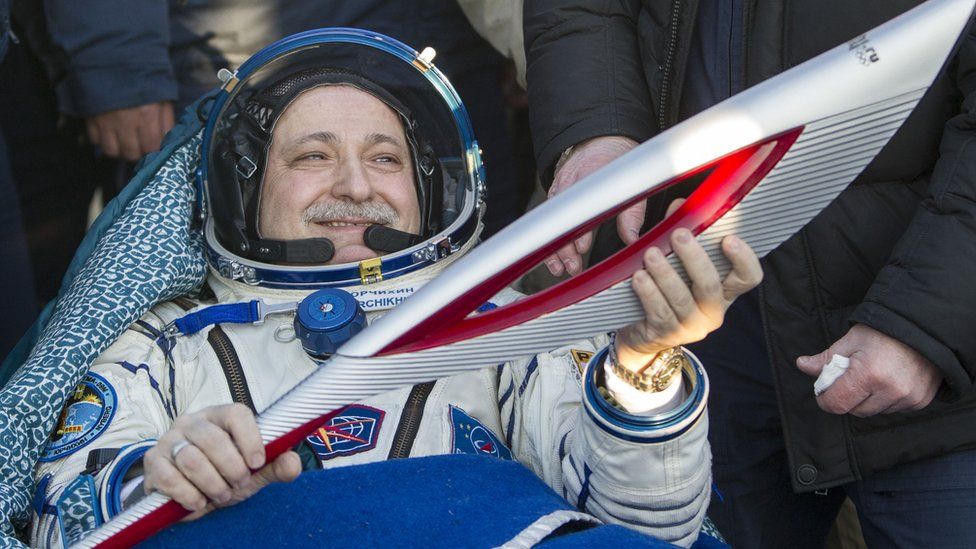 Cosmonaut Fyodor Yurchikhin with the 2014 Sochi winter Olympic Games torch after landing.
