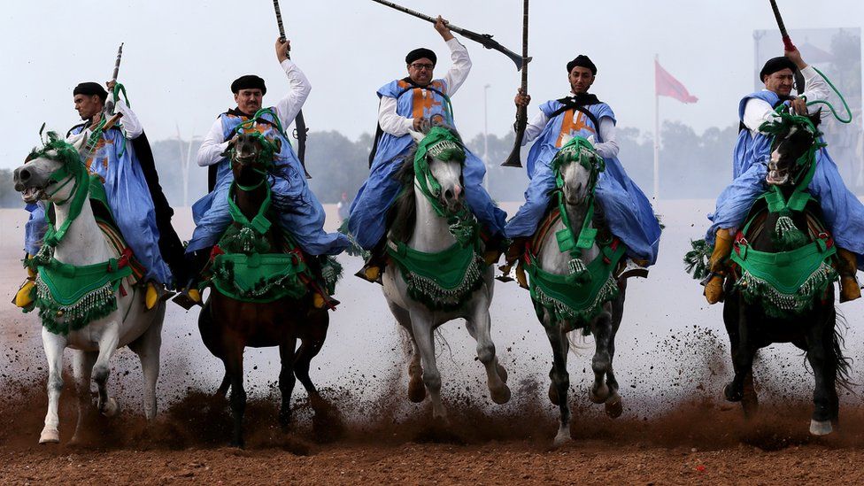 Traditional Moroccan knights ride in an equestrian show during the Festival of Tbourida, a competition between the Moroccan tribes, in Al-Jadidah, Morocco, 18 October 2017. Tbourida is a traditional exhibition of horsemanship in the Maghreb performed during cultural festivals and to close Maghrebi wedding celebrations. The performance consists of a group of horse riders, all wearing traditional clothes, who charge along a straight path at the same speed so as to form a line, the pickup speed and then at the end of the charge, fire into the sky using old muskets or muzzle-loading rifles