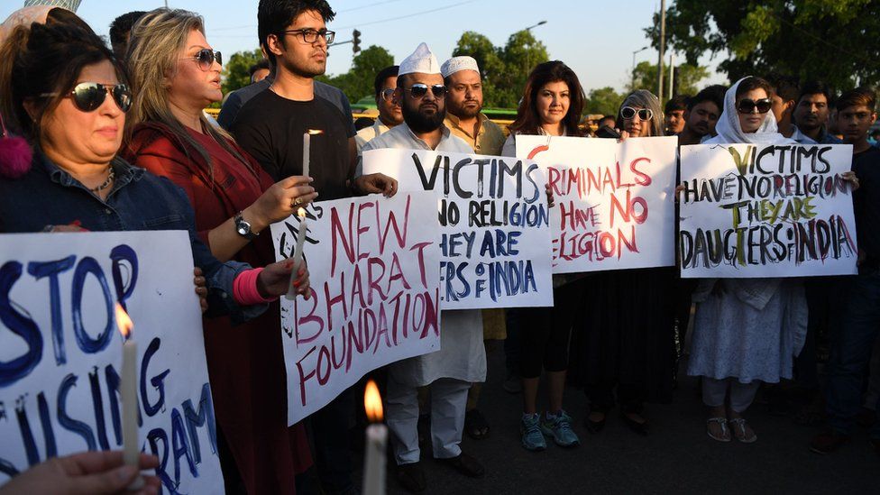 Indian demonstrators gather at the India Gate monument for a candlelight vigil in protest over the gang rape and murder of an eight-year-old girl, in New Delhi on April 14, 201