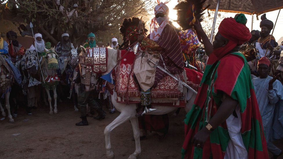 Emir passing through Kano on horseback