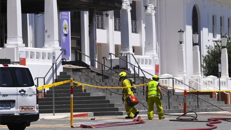 Fire fighters enter the fire damaged entrance to Old Parliament House are seen in Canberra, Australia, 30 December 2021.