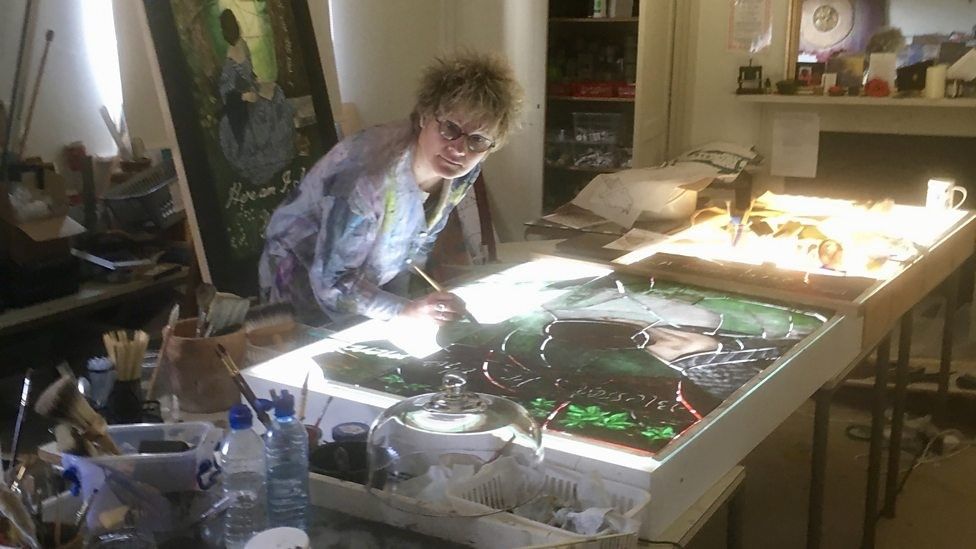 Sophie Hacker working on a stained glass window