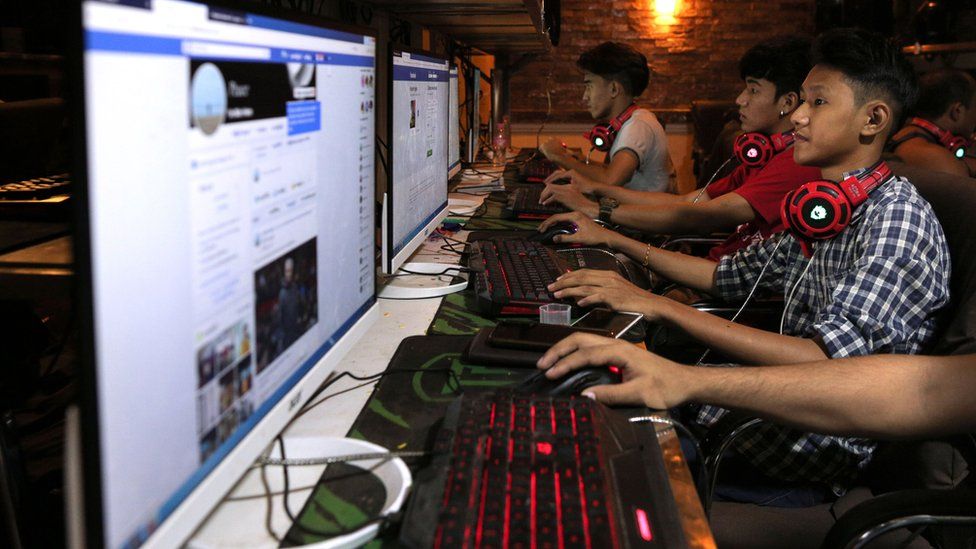 This picture taken on December 18, 2018 shows Myanmar youths browsing their Facebook page at an internet shop in Yangon.