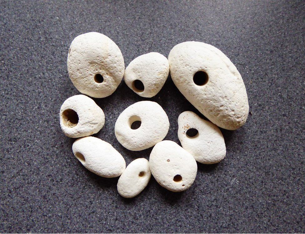 White stones with holes in them