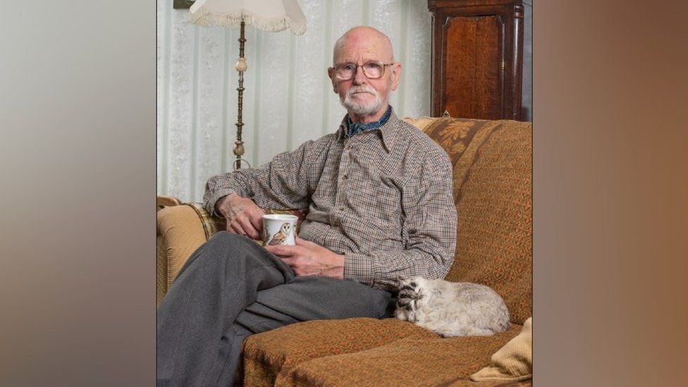 One of the photographer's subjects at home with a cup of tea