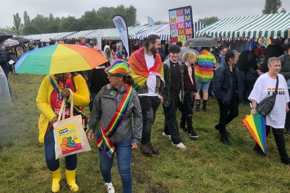 People with umbrellas at Pride on Saturday