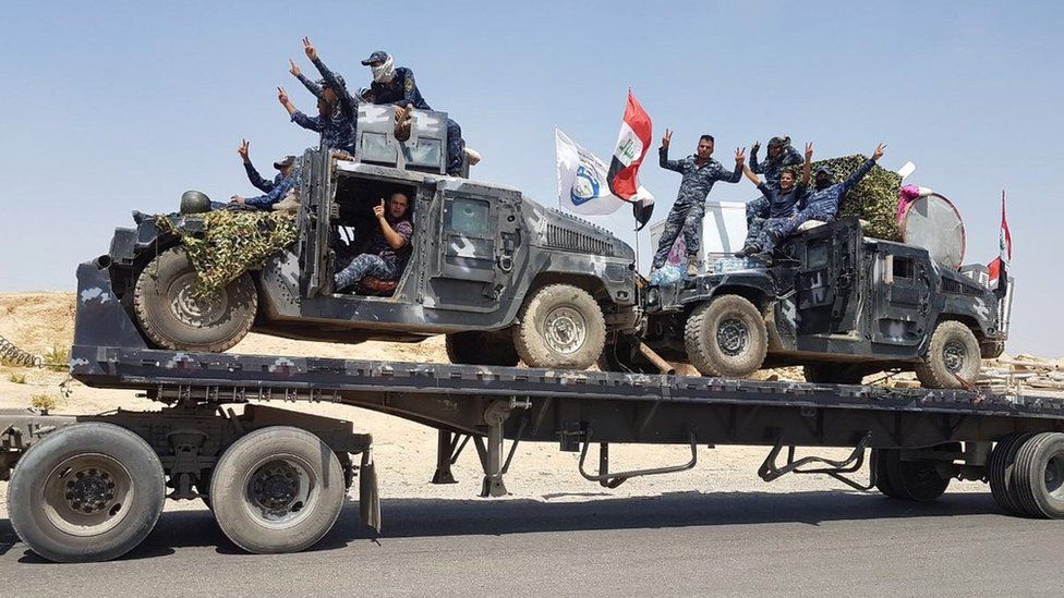 Iraqi federal police armoured vehicles are transported to the frontline outside Tal Afar (15 August 2017)