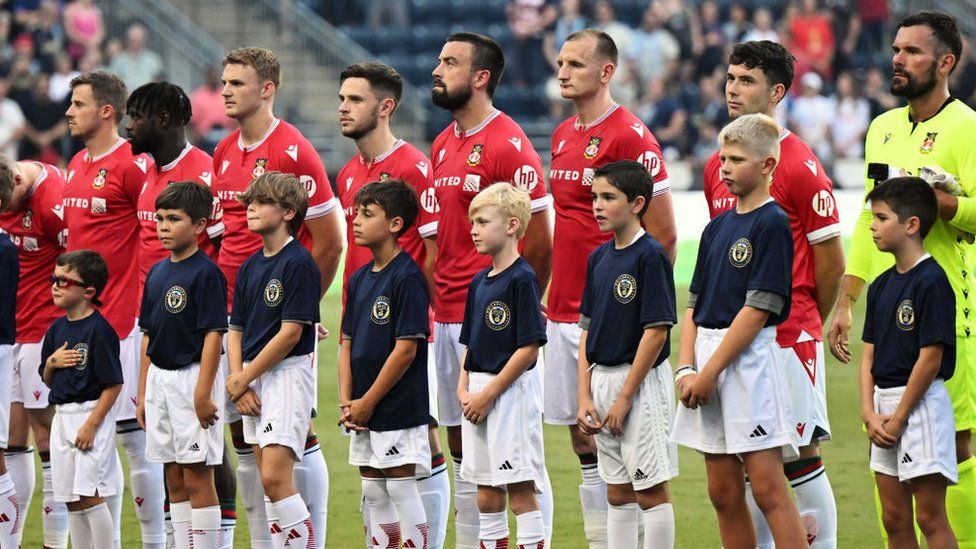 CHESTER, PENNSYLVANIA - JULY 28: Wrexham AFC players stand for the national anthem before the pre-season friendly against the Philadelphia Union II at Subaru Park on July 28, 2023 in Chester, Pennsylvania.