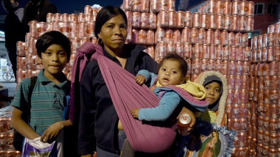 A family of pilgrims poses for portrait during their procession near of Basilica de Guadalupe in Mexico City on December 11, 2017 to mark the birthday of the Virgin of Guadalupe.