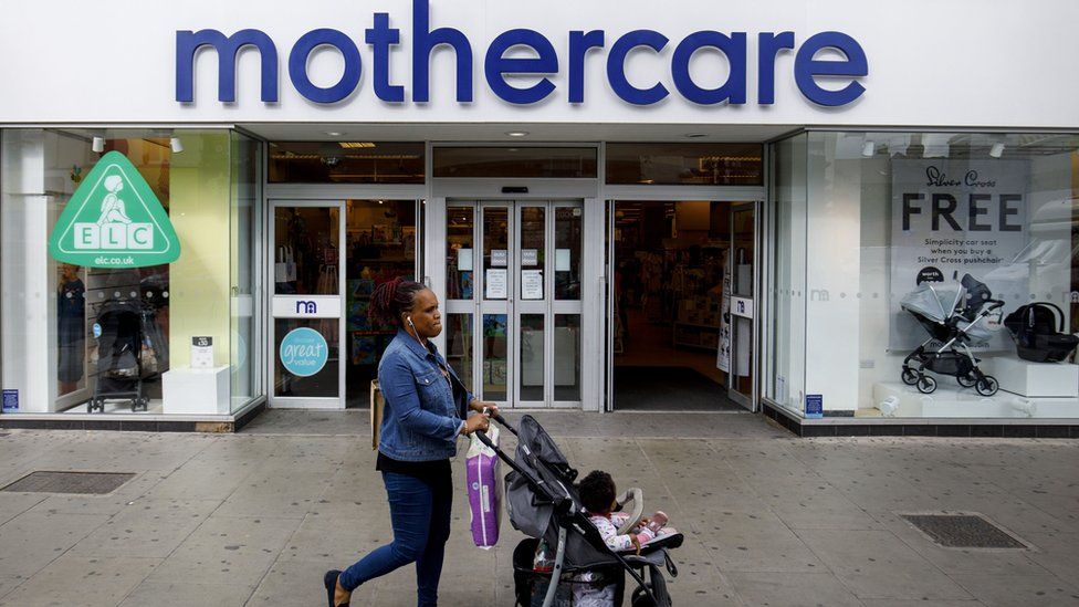 Woman in front of Mothercare store