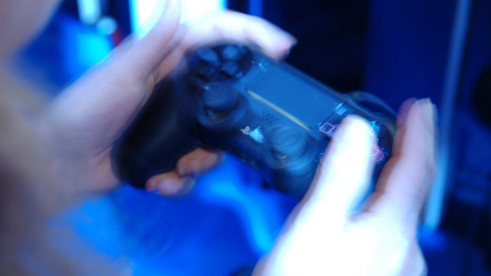 Close up hands on games controller