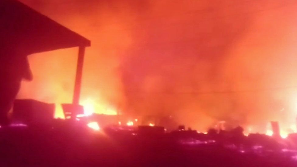 A still from footage of the town of Munyenge shows it on fire