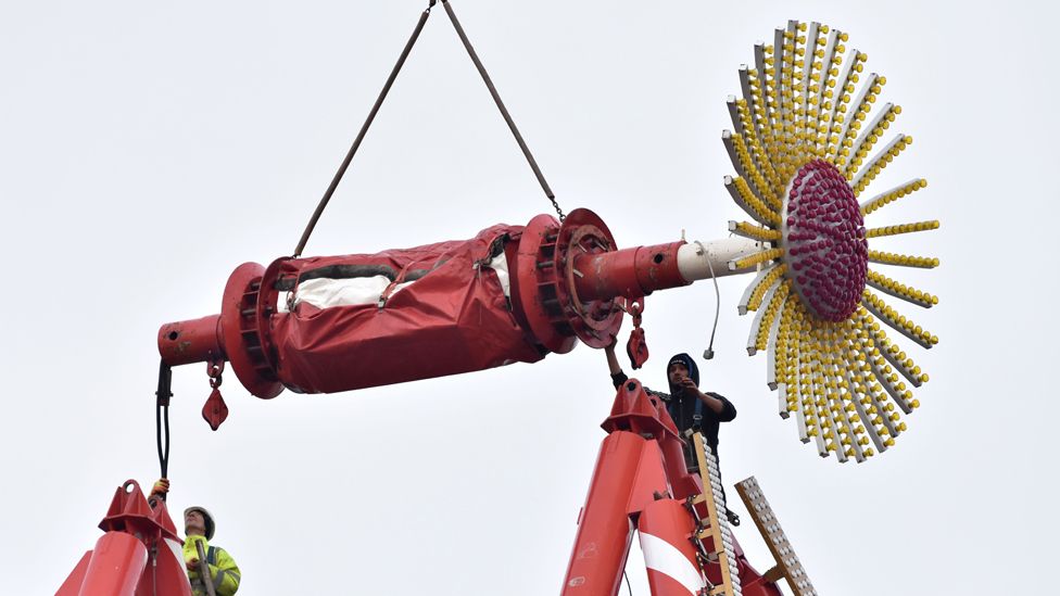 Christmas light being moved into position