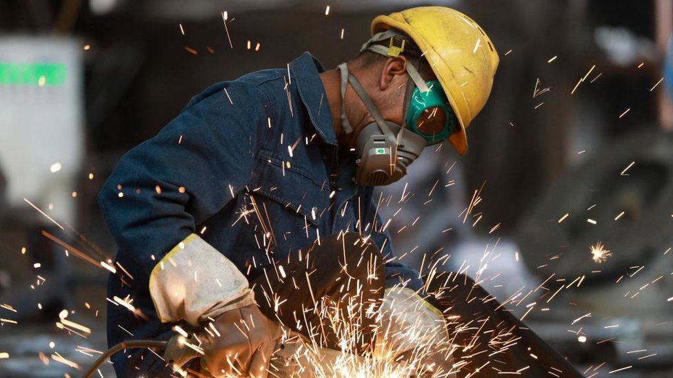 A worker polishes metal at a factory in Hangzhou in China's eastern Zhejiang province.