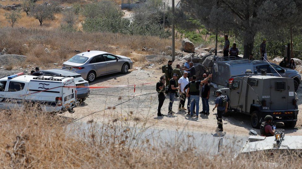 Israeli security forces inspect the scene of a deadly shooting attack south of Hebron, in the occupied West Bank (21 August 2023)