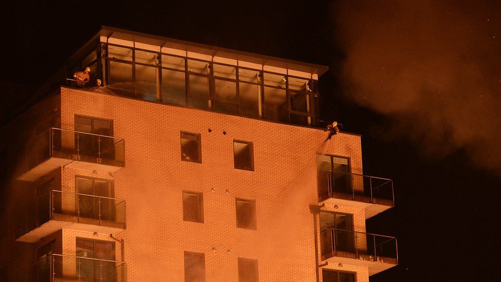 Fire crews sprayed water on the apartment block to prevent the fire spreading