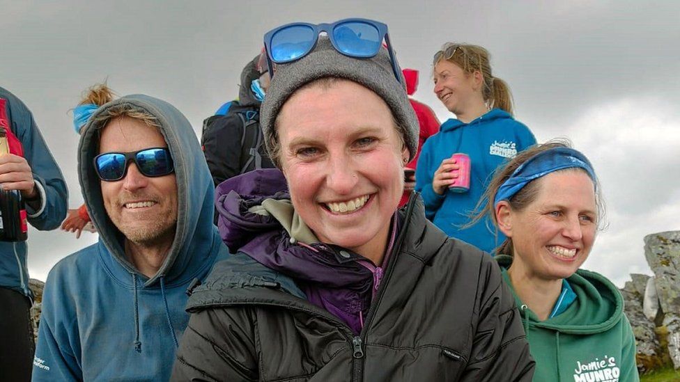 Ultra-runner Jamie Aarons celebrates with supporters after scaling all 282 Munros in Scotland