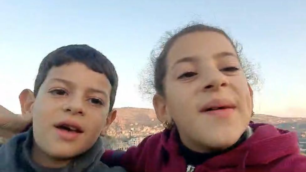 Amr (left) with his sister in a still from a video they recorded
