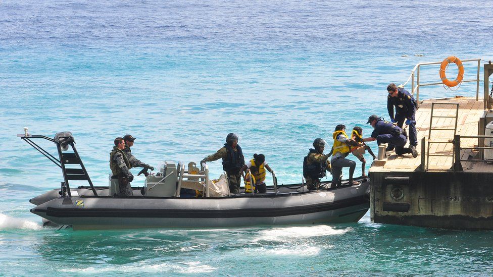 Australia navy delivers asylum seekers, intercepted on a boat, to Christmas Island (file image from 2013)