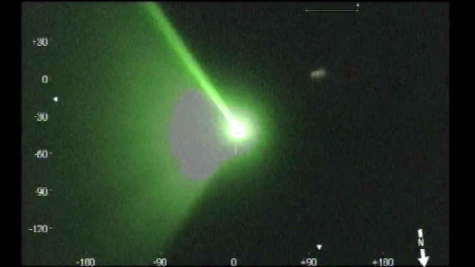 A laser beam aimed at the helicopter