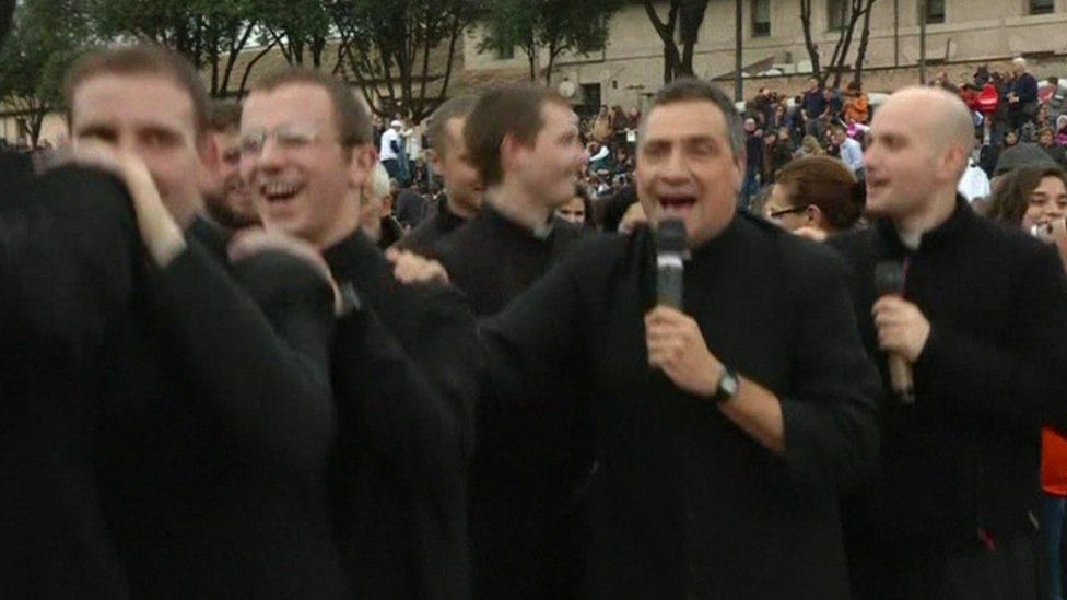 Catholic priests dance the conga at a anti same-sex union rally