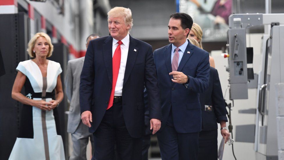 US President Donald Trump and Wisconsin Governor Scott Walker (R) arrive for a workforce development roundtable discussion at Waukesha County Technical College during a visit in Milwaukee, Wisconsin on June 13, 2017.