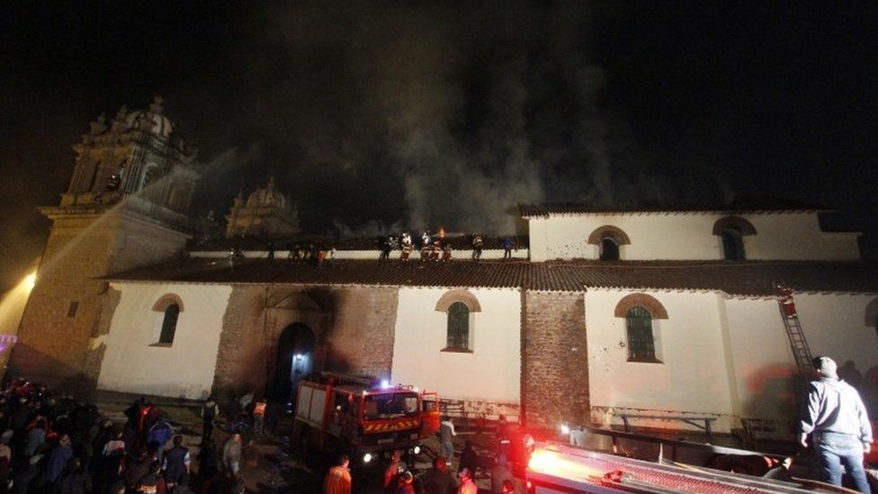 Firefighters work to extinguish a fire at the 16th-Century San Sebastian church in Cuzco, Peru.