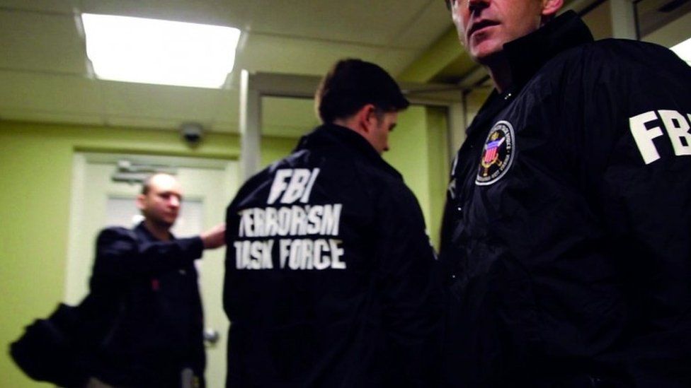 FBI Special Agents and members of the Joint Terrorism Task Force prepare to arrest a suspect