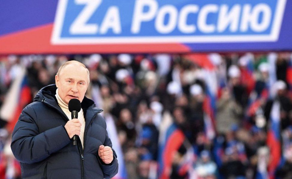 Russian President Vladimir Putin gives a speech at a concert marking the eighth anniversary of Russia's annexation of Crimea at the Luzhniki stadium