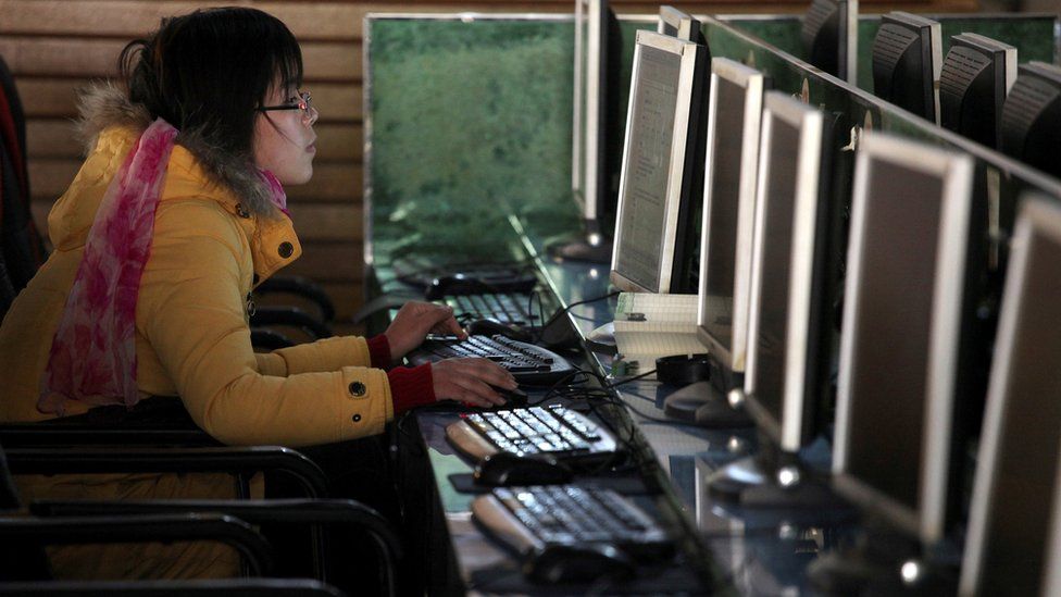 File image of a woman using a computer in an internet cafe in Shanghai