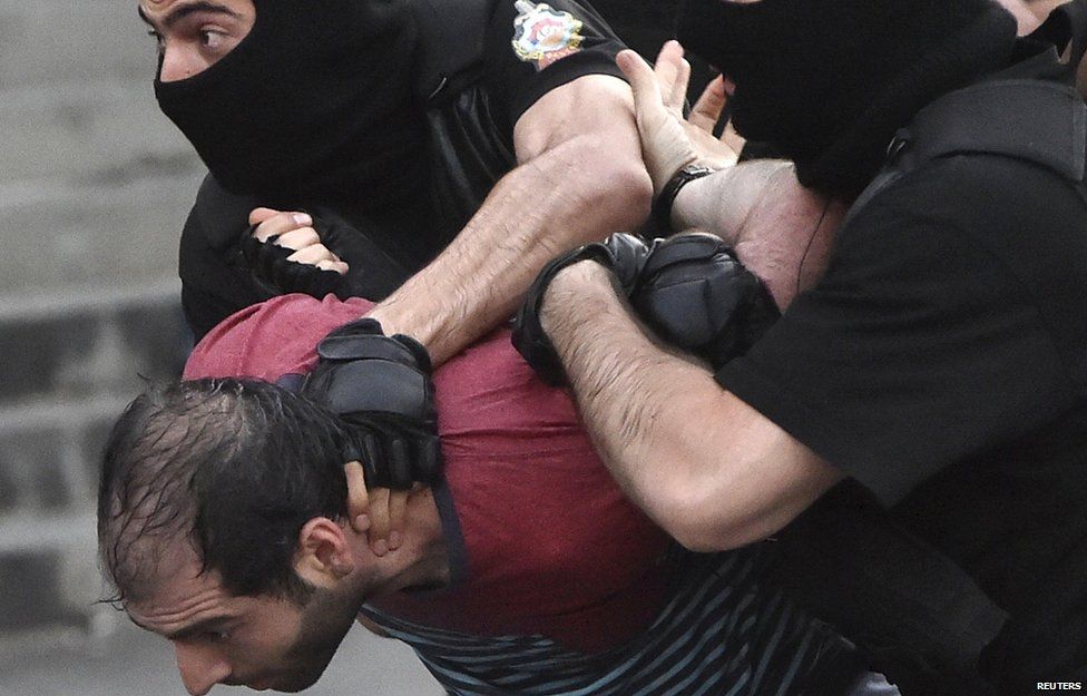 A demonstrator is detained by riot police during a rally against a recent decision to raise public electricity prices in Yerevan, Armenia on 22 June