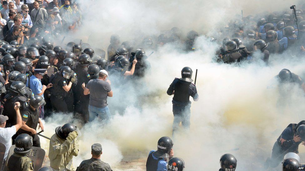 Smoke engulfs police and protestors outside parliament