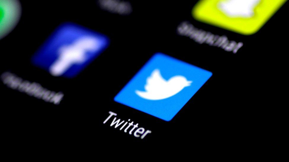 Twitter app logo seen in sharp focus on a phone screen