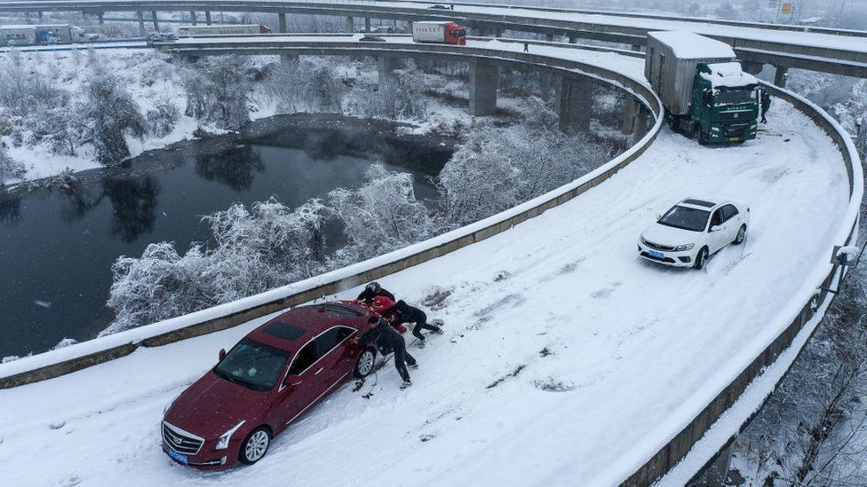 Cars are stuck on a highway due to heavy snow in Wuhan, in central China's Hubei province on February 6, 2024