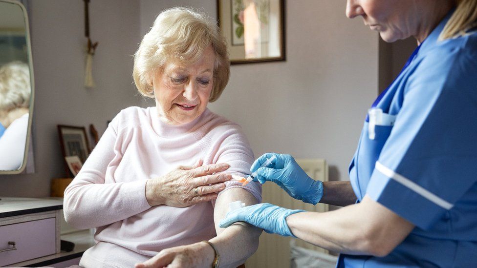 Woman receiving a flu jab