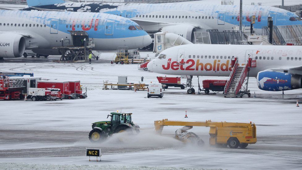 Snow is seen on the runways of Manchester Airport