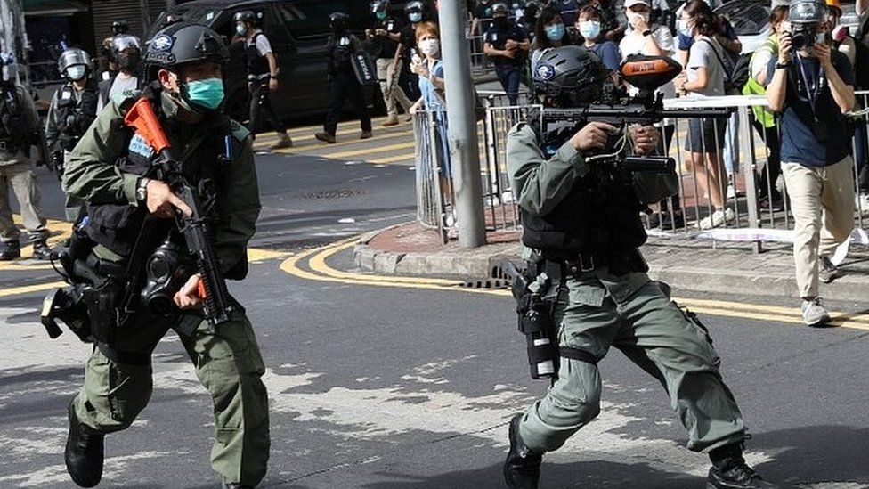 Riot police fire pepper spray in Hong Kong
