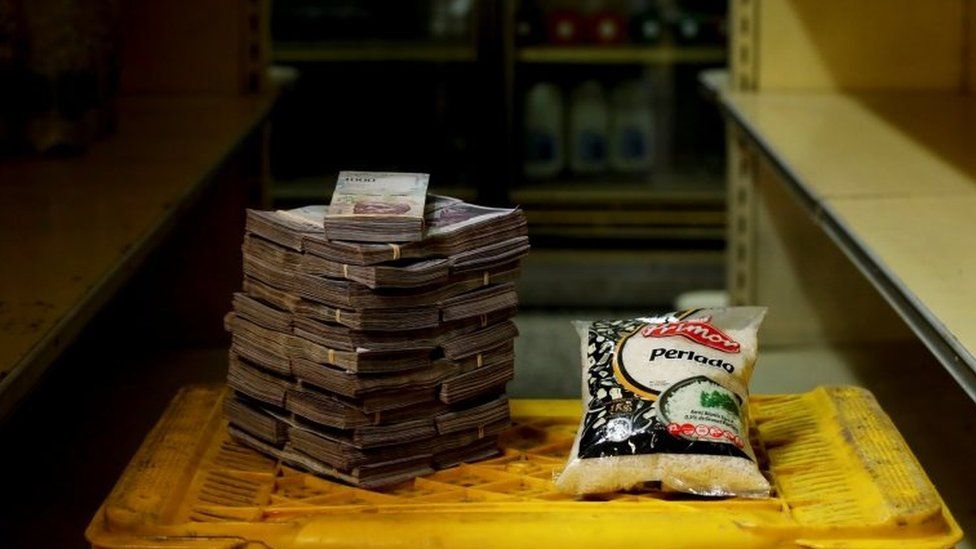 A package of 1kg of rice is pictured next to 2,500,000 bolivars, its price at a mini-market in Caracas, Venezuela